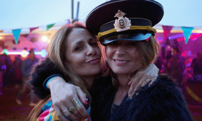 Festivalgoers dancing at Campo Sancho with colourful lights and countryside backdrop at Walkern Hall