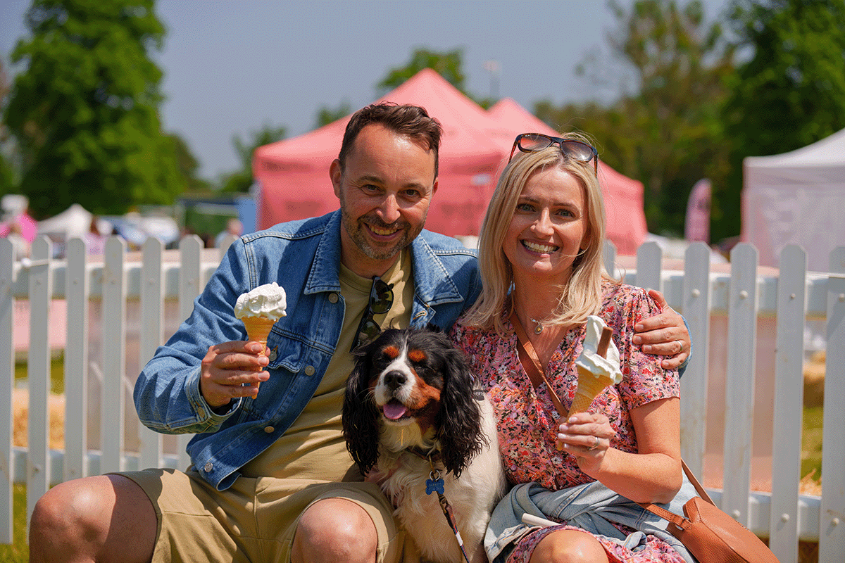 Front view of Blenheim Palace on a bright summer day, with visitors enjoying the grounds