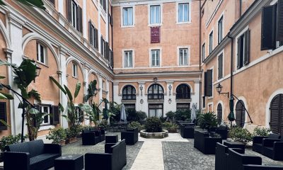 Courtyard at Hotel Antico Palazzo Rospigliosi in central Rome with outdoor seating and historic architecture
