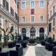 Courtyard at Hotel Antico Palazzo Rospigliosi in central Rome with outdoor seating and historic architecture